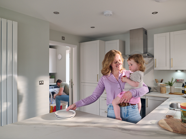 a mother and toddler in a modern white kitchen