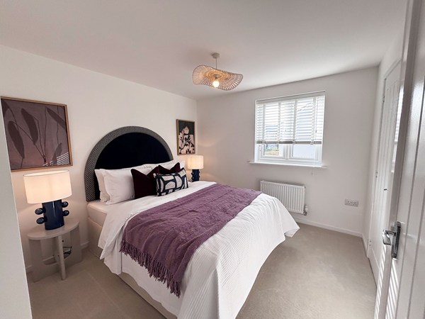 Bright double bedroom with feature artwork at Trevithick Manor Park new-build.