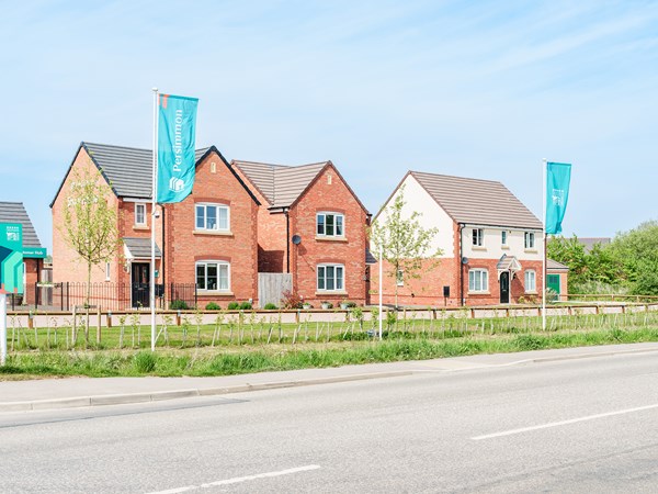 Modern red-brick Persimmon Homes at The Maples development in Spalding, Lincolnshire with roadside view.