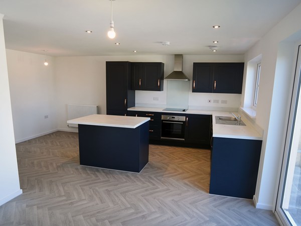 Modern kitchen with island in the Brampton at Trehenlis Gardens.