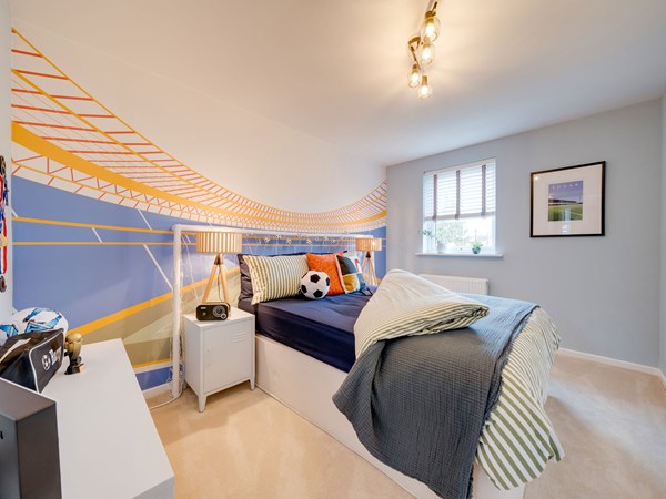 Kielder bedroom with football-themed feature wall and double bed