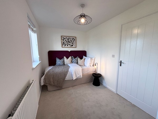 Stylish bedroom with contemporary décor in a new-build home at Trevithick Manor Park.