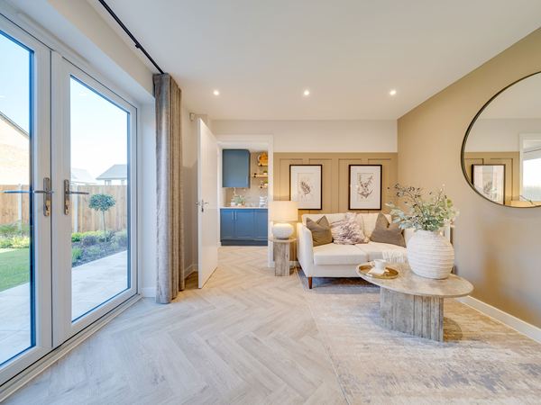 Dining area in The Burnham at Bluebell Meadow with patio doors and open-plan layout.