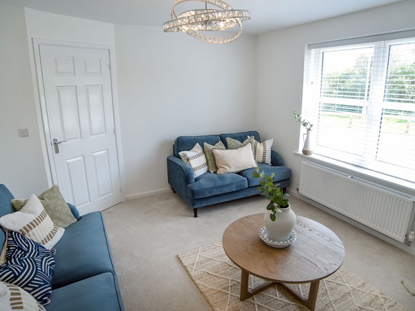Living room with large window in the Greenwood at Trehenlis Gardens.