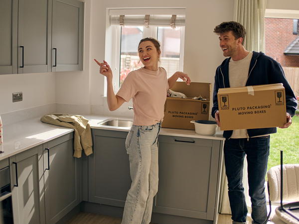 Young first time buyer couple in kitchen