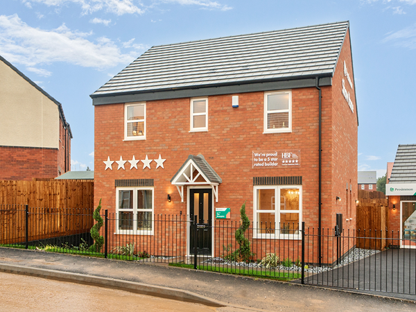 Front exterior of a modern red-brick new build home with fenced garden.