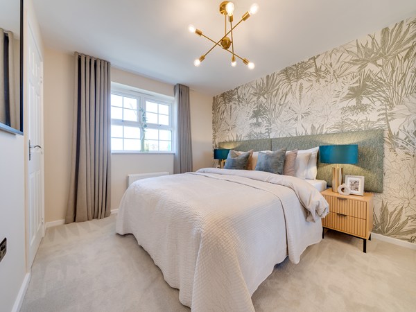 Bedroom 1 with large bed and neutral tree print wallpaper
