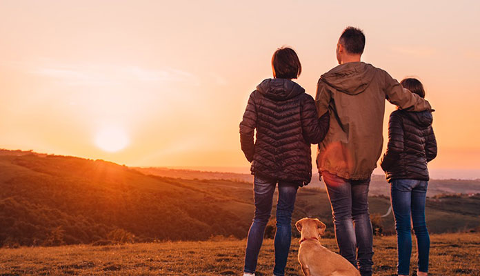 Family and Dog Watching Sunset