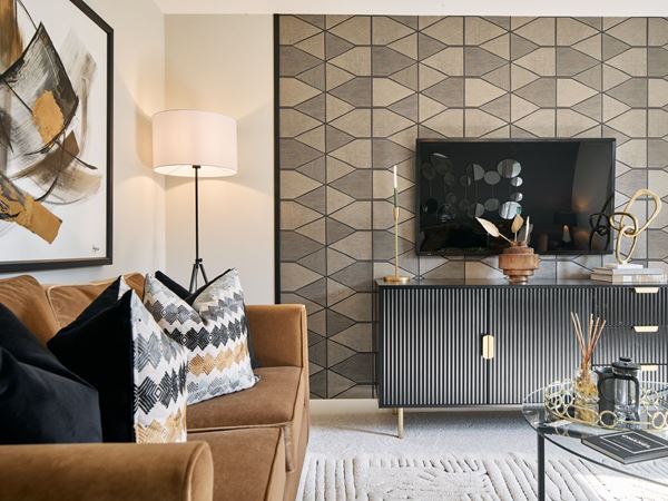A modern living room in a new Persimmon home, with a brown sofa and brown accessories.
