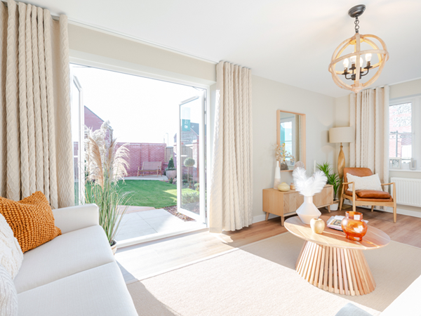 Bright living room with French doors opening onto a view of the garden
