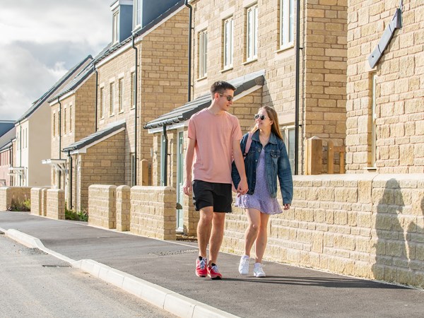 Young couple walking on a Persimmon Homes development