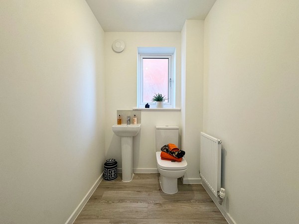 WC in the Wykeham new build home with basin, toilet and window.