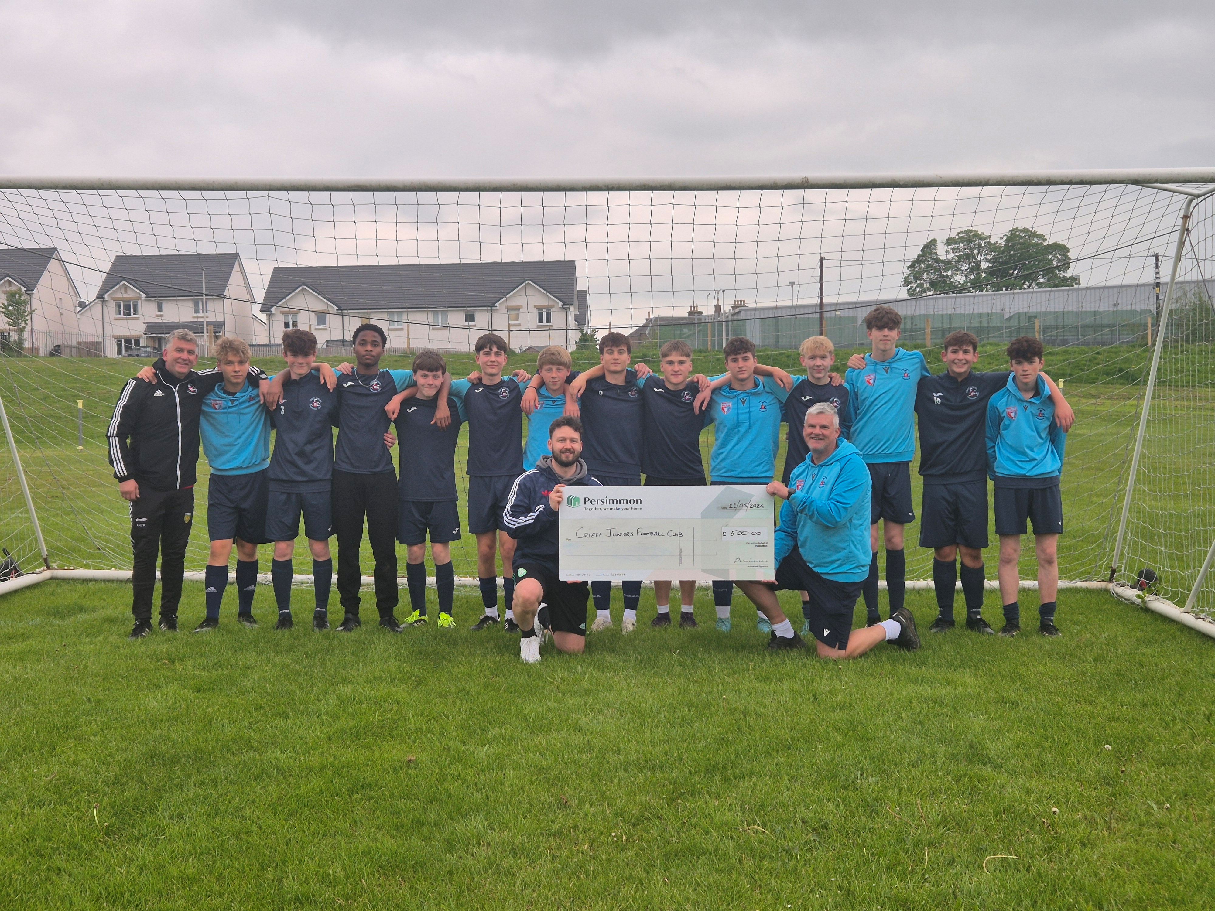 Crieff Juniors holding up Persimmon cheque