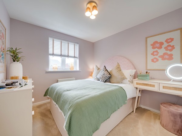 Kielder bedroom with double bed, dressing table and pink walls