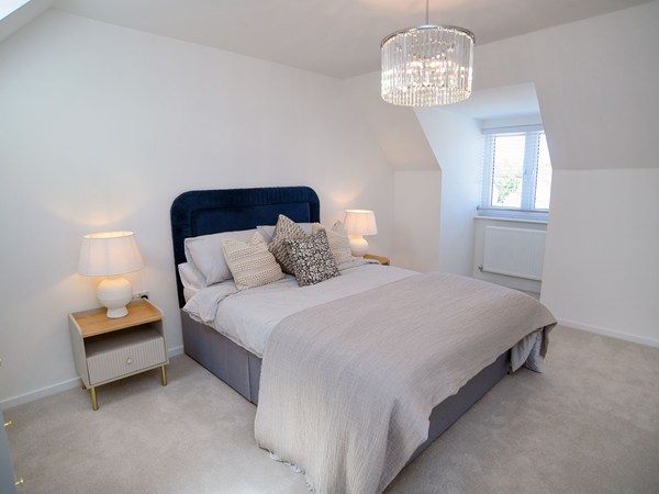Styled double bedroom with window alcove in the Greenwood at Trehenlis Gardens.