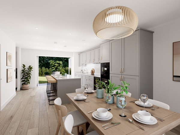 Spacious open-plan kitchen and dining area with light gray cabinets, white countertops, and a central island with wooden bar stools. A wooden dining table set for six sits in the foreground, and large glass doors open to a garden, allowing abundant natural light.