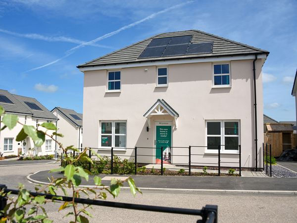 Front view of a new build home with solar panels at Trehenlis Gardens.