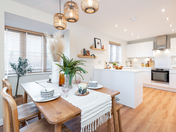 Open plan kitchen/dining room. white kitchen decor, with wooden dining table