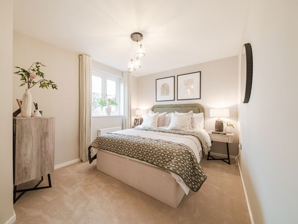 Spacious bedroom with double bed, bedside tables and large window.