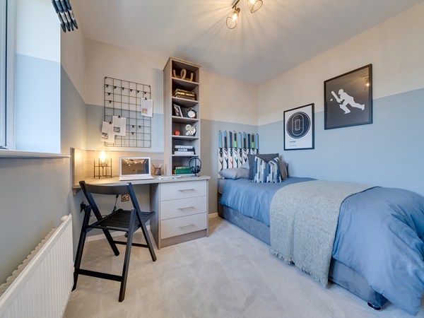 Bedroom 3 with a single grey bed, a desk with laptop and baseball theme room decor