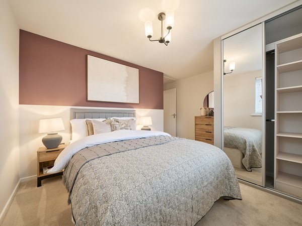 Elegant-double-bedroom-with-feature-accent-wall-mirrored-wardrobes-soft-lighting-and-neutral-furnishings
