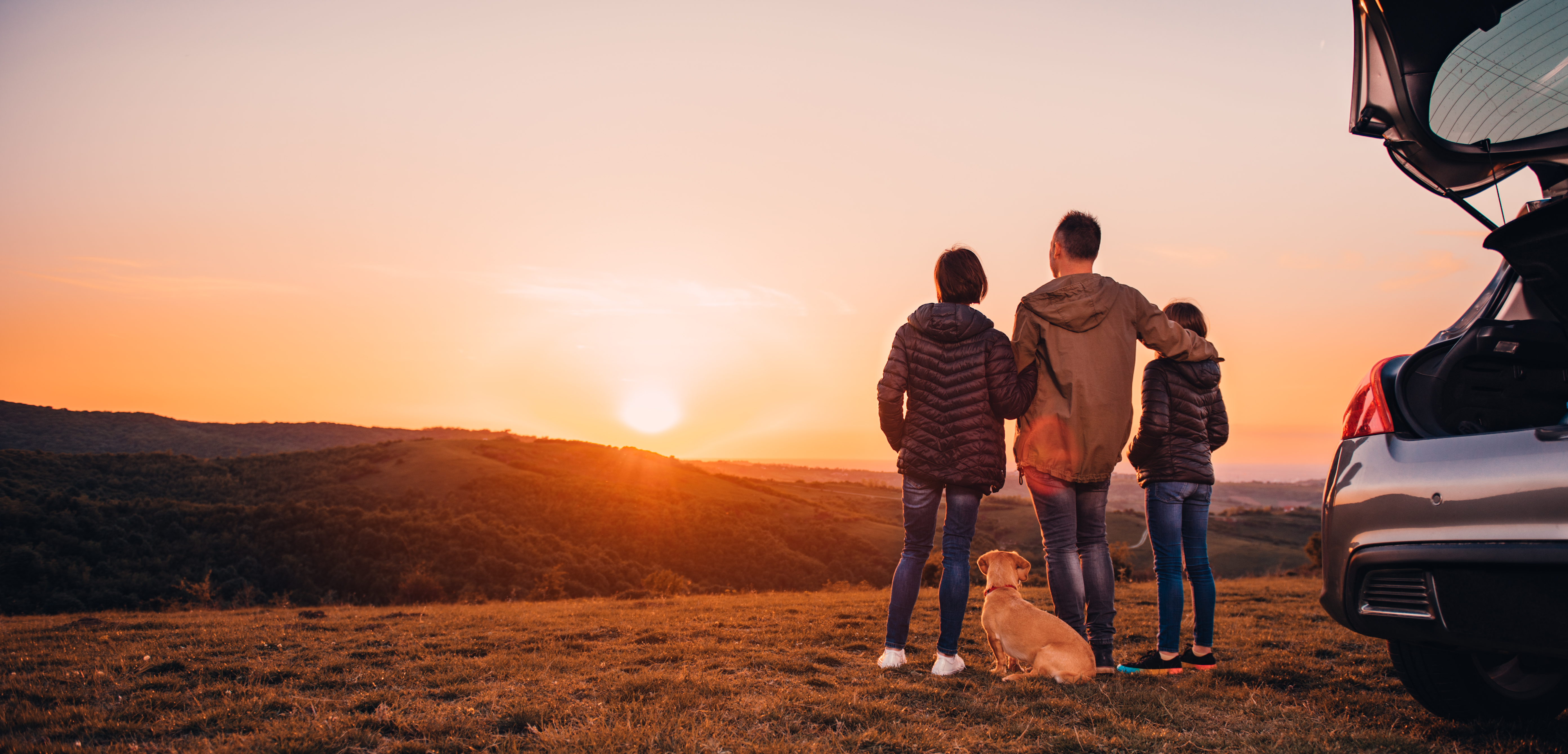 Family On A Hill Watching Sunset