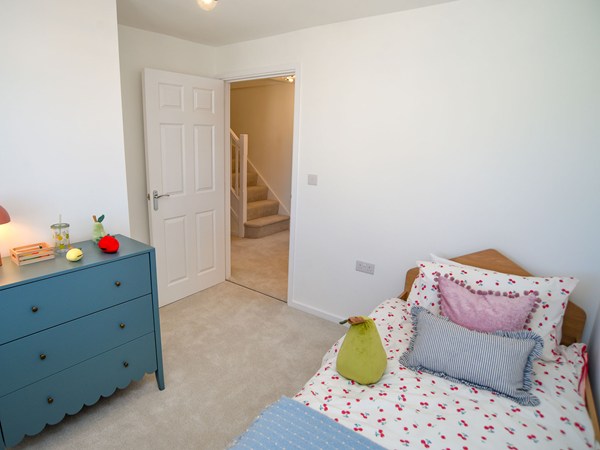 Single bedroom with colourful styling in the Greenwood at Trehenlis Gardens.