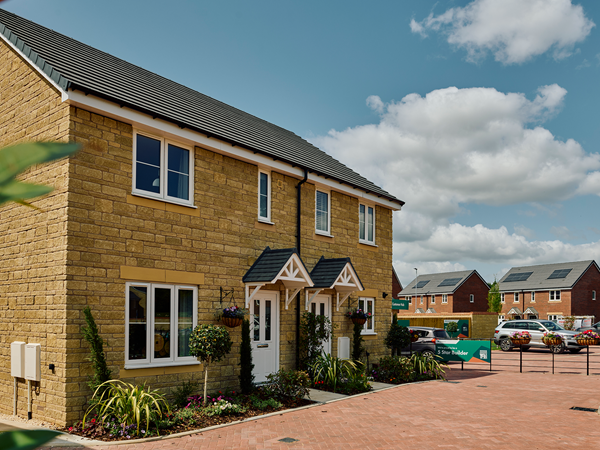 two semi detached Persimmon houses with stone facade