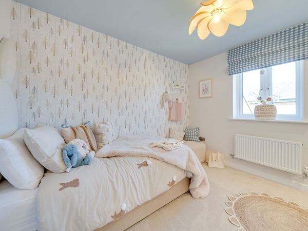 Main bedroom in The Burnham at Bluebell Meadow with mirrored wardrobes and feature headboard.