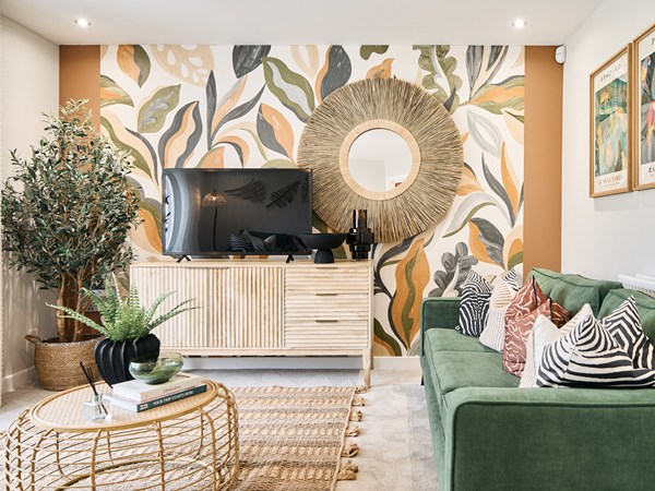 Modern living room with green sofa at Persimmon Homes The Maples development in Bewdley, Worcestershire