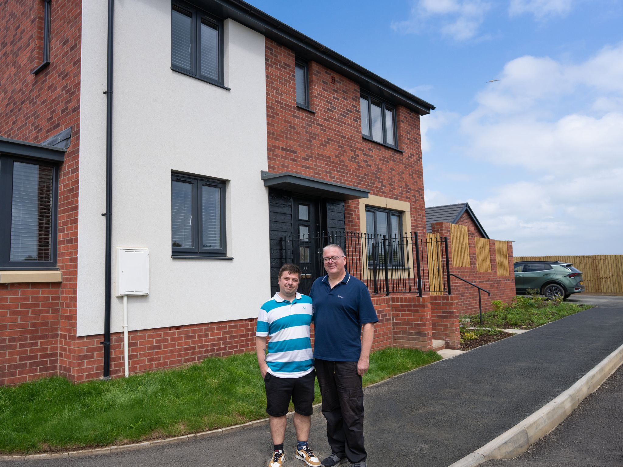 Persimmon customer Sean standing outside his fifth Persimmon home.