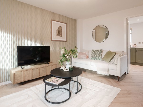 Modern living room with sofa, television and patterned feature wall.